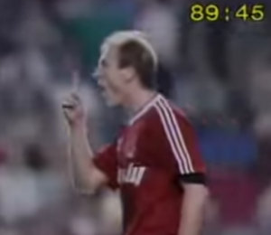 Photo of Steve McMahon at Anfield 89 holding up one finger to indicate Liverpool just needed to hold on for one minute